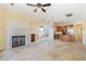 Spacious living room with fireplace and travertine flooring at 26 Via Vasari # 204, Henderson, NV 89011