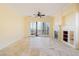Spacious living room with fireplace and access to a balcony at 26 Via Vasari # 204, Henderson, NV 89011