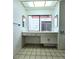 Bathroom vanity area with mirrors and a view out to the backyard at 3058 Conquista Ct, Las Vegas, NV 89121
