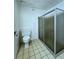 Bathroom featuring a toilet and shower with glass door and tile floors at 3058 Conquista Ct, Las Vegas, NV 89121