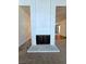 Living room fireplace featuring a white painted brick surround and black iron doors at 3058 Conquista Ct, Las Vegas, NV 89121