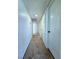 Bright hallway with neutral carpeting and multiple storage closets at 3058 Conquista Ct, Las Vegas, NV 89121