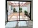 View from inside the bedroom looking out into a small enclosed patio with desert landscaping at 3058 Conquista Ct, Las Vegas, NV 89121