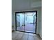 Enclosed patio with brick floors, view from inside the home through sliding glass doors at 3058 Conquista Ct, Las Vegas, NV 89121