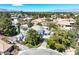Stunning aerial view of the property showcasing a large home with a pool, mature trees, and well-manicured landscaping at 3111 Coachlight Cir, Las Vegas, NV 89117