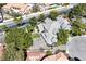 A spacious home with a three-car garage, complemented by lush landscaping, offers privacy and curb appeal in an aerial view at 3111 Coachlight Cir, Las Vegas, NV 89117