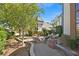 Outdoor patio with seating and view of the well maintained backyard and landscaping at 3111 Coachlight Cir, Las Vegas, NV 89117