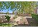Beautifully landscaped backyard featuring lush greenery, a stone path, and mature trees at 3111 Coachlight Cir, Las Vegas, NV 89117