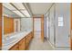 Bright bathroom features double sinks, a large mirror, and a glass enclosed shower at 3111 Coachlight Cir, Las Vegas, NV 89117