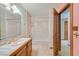 Bathroom showing the sink, bathtub, tiled shower, and a wooden door at 3111 Coachlight Cir, Las Vegas, NV 89117