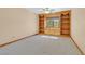 Bedroom featuring custom built-in shelving and a window with natural light at 3111 Coachlight Cir, Las Vegas, NV 89117