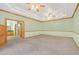 Large bedroom with plush carpet, tray ceiling, ample natural light, and built-in cabinets, connecting to an en-suite bathroom at 3111 Coachlight Cir, Las Vegas, NV 89117