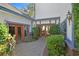 Private courtyard with brick pathways, decorative landscaping, and double door entrances offer curb appeal and seclusion at 3111 Coachlight Cir, Las Vegas, NV 89117
