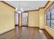 Sunlit dining room with hardwood floors, classic chandelier, and view to the foyer at 3111 Coachlight Cir, Las Vegas, NV 89117