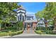 Detailed front exterior showcasing the ornate doorway, turret, landscaping, and brick facade at 3111 Coachlight Cir, Las Vegas, NV 89117