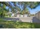 A well-maintained exterior showcasing a spacious three-car garage, a neatly paved driveway, and a lush green lawn at 3111 Coachlight Cir, Las Vegas, NV 89117