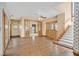 Elegant foyer with hardwood floors, staircase, wood trim and doors, and views to other rooms at 3111 Coachlight Cir, Las Vegas, NV 89117