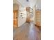 Foyer with hardwood floors and a custom wooden spiral staircase at 3111 Coachlight Cir, Las Vegas, NV 89117