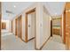 Hallway with multiple doors and wood trim, showcasing access to various rooms at 3111 Coachlight Cir, Las Vegas, NV 89117