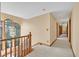 Bright hallway with wood banister and trim, illuminated by large windows at 3111 Coachlight Cir, Las Vegas, NV 89117
