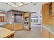 Kitchen with gas range, stainless steel appliances, brick accents and tile flooring at 3111 Coachlight Cir, Las Vegas, NV 89117