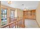 An upstairs landing with windows overlooking the pool and built-in cabinetry at 3111 Coachlight Cir, Las Vegas, NV 89117