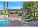 Inviting poolside patio area with comfortable seating under a pergola, ideal for enjoying the outdoors and relaxing by the pool at 3111 Coachlight Cir, Las Vegas, NV 89117