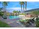 Beautiful backyard with a sparkling pool, rock waterfall, mature trees and lounge chairs at 3111 Coachlight Cir, Las Vegas, NV 89117