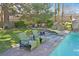 Backyard with a hot tub and swimming pool complete with rock waterfall and seating area at 3111 Coachlight Cir, Las Vegas, NV 89117