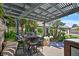 Charming outdoor dining area under a pergola, providing a delightful space for entertaining and enjoying meals in the backyard at 3111 Coachlight Cir, Las Vegas, NV 89117