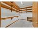 Spacious walk-in closet featuring custom wooden shelving for ample storage at 3111 Coachlight Cir, Las Vegas, NV 89117