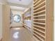 Spacious walk-in closet with abundant shelving and a unique window for natural light and ventilation at 3111 Coachlight Cir, Las Vegas, NV 89117