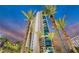 Exterior of a modern high-rise residential building surrounded by palm trees at 322 Karen Ave # 703, Las Vegas, NV 89109