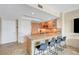 Modern kitchen features granite countertops, wood cabinetry, stainless steel sink, and seating at the breakfast bar at 322 Karen Ave # 703, Las Vegas, NV 89109