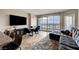 Open-concept living area with dining table, sectional sofa and balcony access at 322 Karen Ave # 703, Las Vegas, NV 89109