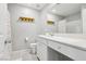 Bright bathroom features a white vanity with solid surface top and a tub/shower combination at 3281 Pergusa Dr, Henderson, NV 89044