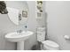 Half bath features a pedestal sink and modern fixtures at 3281 Pergusa Dr, Henderson, NV 89044