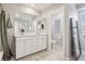 Bright bathroom featuring a double vanity, large mirror and tile flooring at 3281 Pergusa Dr, Henderson, NV 89044