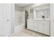 Bathroom featuring dual sinks, vanity, tub and shower, and stylish neutral decor at 3281 Pergusa Dr, Henderson, NV 89044