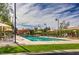 A community pool surrounded by shaded seating areas and manicured lawns at 3281 Pergusa Dr, Henderson, NV 89044