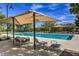 Community pool with lounge chairs and shade structures, surrounded by landscaped areas at 3281 Pergusa Dr, Henderson, NV 89044