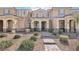 Inviting townhome with a covered entryway, desert landscaping, and a tiled roof at 3281 Pergusa Dr, Henderson, NV 89044