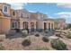 Townhome with desert landscaping, a covered entryway, and a tile roof at 3281 Pergusa Dr, Henderson, NV 89044
