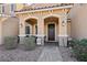Welcoming front porch with seating, desert landscaping, and a dark wood front door at 3281 Pergusa Dr, Henderson, NV 89044