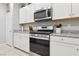 Modern kitchen design with stainless steel appliances and white cabinets at 3281 Pergusa Dr, Henderson, NV 89044