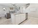 Kitchen island with white cabinetry opens to the living room space at 3281 Pergusa Dr, Henderson, NV 89044