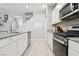 White cabinet kitchen with stainless steel appliances and granite counters at 3281 Pergusa Dr, Henderson, NV 89044