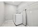 Functional laundry room equipped with a washer, dryer, shelving and ironing board at 3281 Pergusa Dr, Henderson, NV 89044