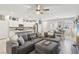 Open-concept living room with kitchen, dining area, comfortable sofa, and modern finishes at 3281 Pergusa Dr, Henderson, NV 89044