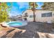 This backyard has an in-ground pool, hot tub, and patio space at 4406 Flowerdale Ct, Las Vegas, NV 89103